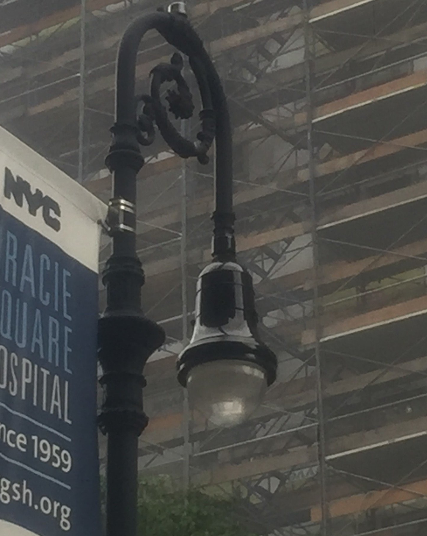 A street light with a sign that says NYC on it