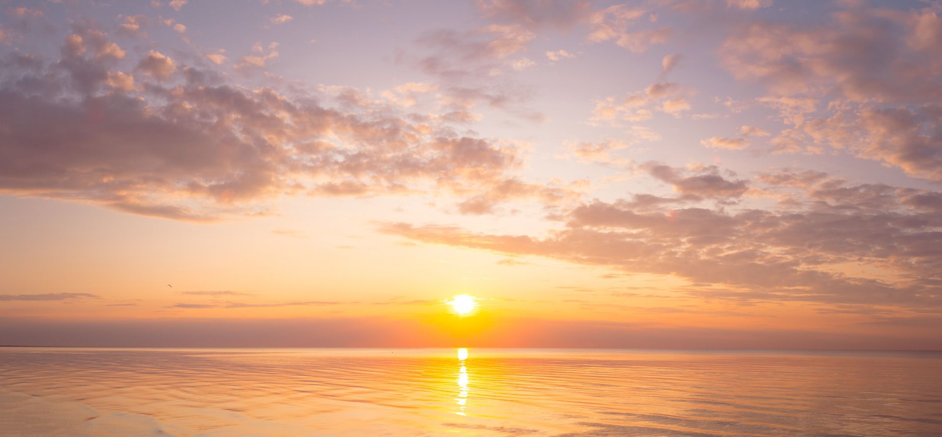 The sun is setting over the ocean.