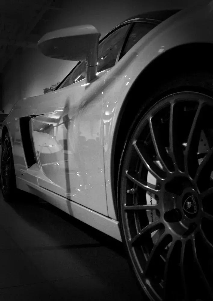 a white car is parked on the side of the road - just applied ceramic coating