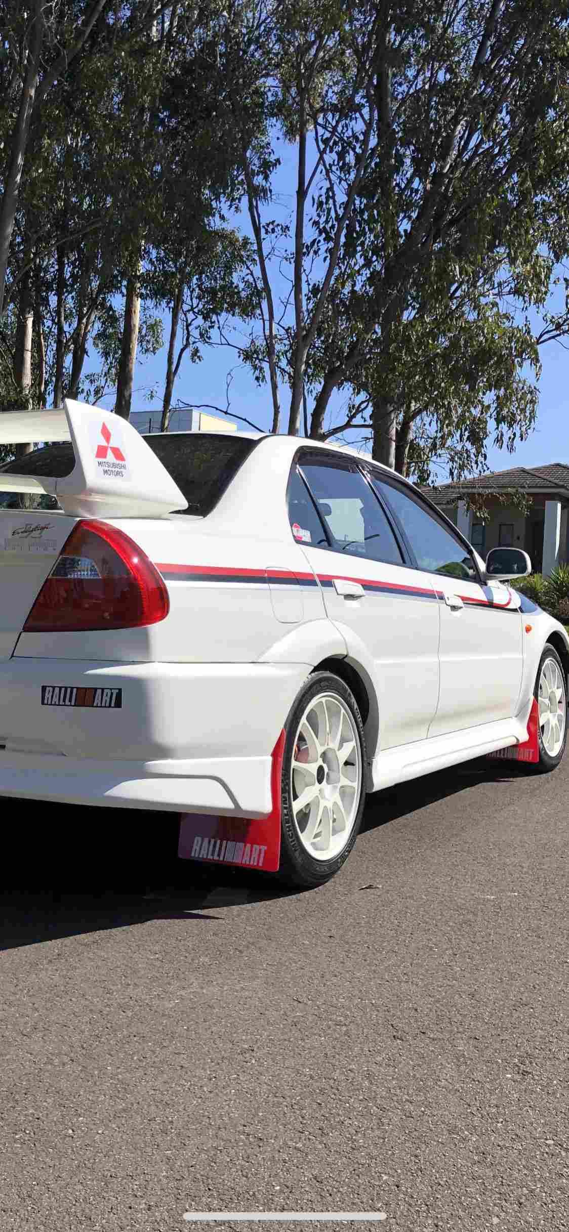 a white mitsubishi car with red and white rally parts - with feylab ceramic coating applies in Rouse Hill