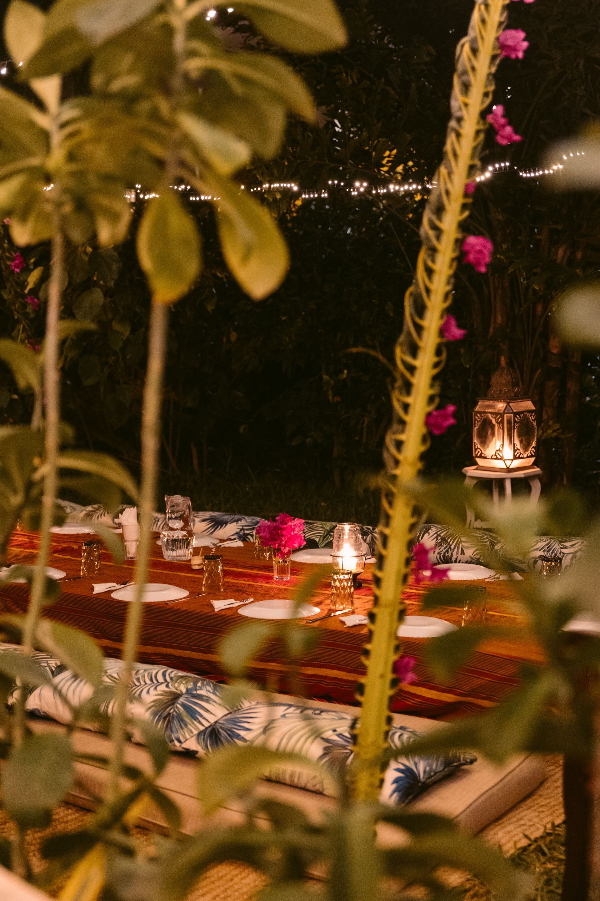 Nighttime garden scene with flowers and warm lights creating a relaxing atmosphere at Banana House