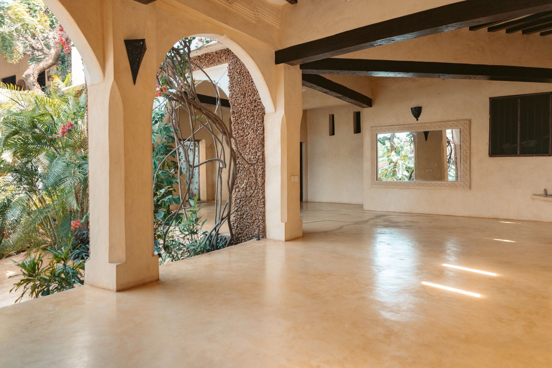 Spacious wellness studio with Swahili arches and garden views used for yoga classes and retreats at Banana House 