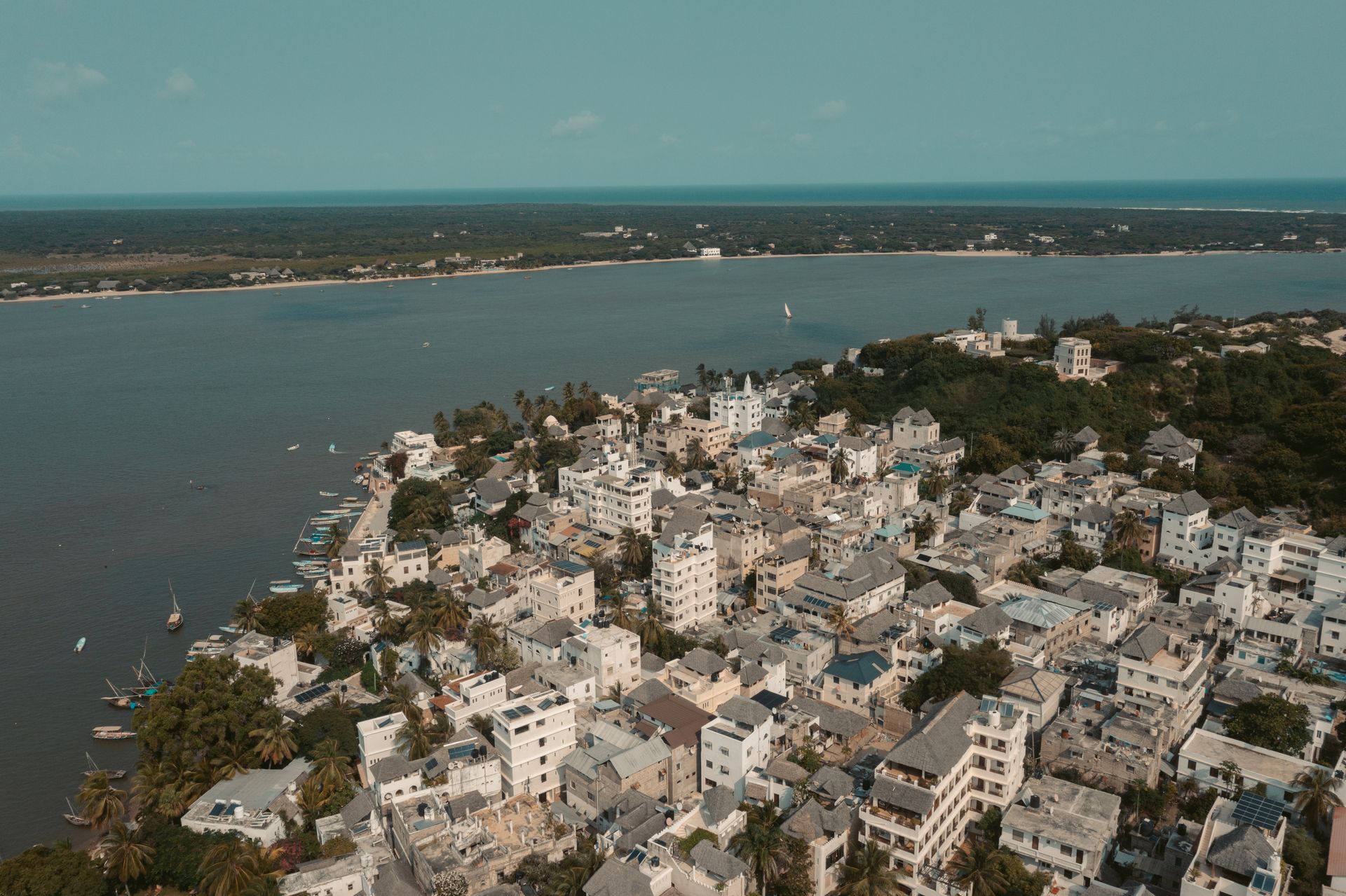 Drone view of Lamu Town's / Shela traditional Swahili buildings along the shoreline of Lamu Island on Kenya’s Indian Ocean coast.