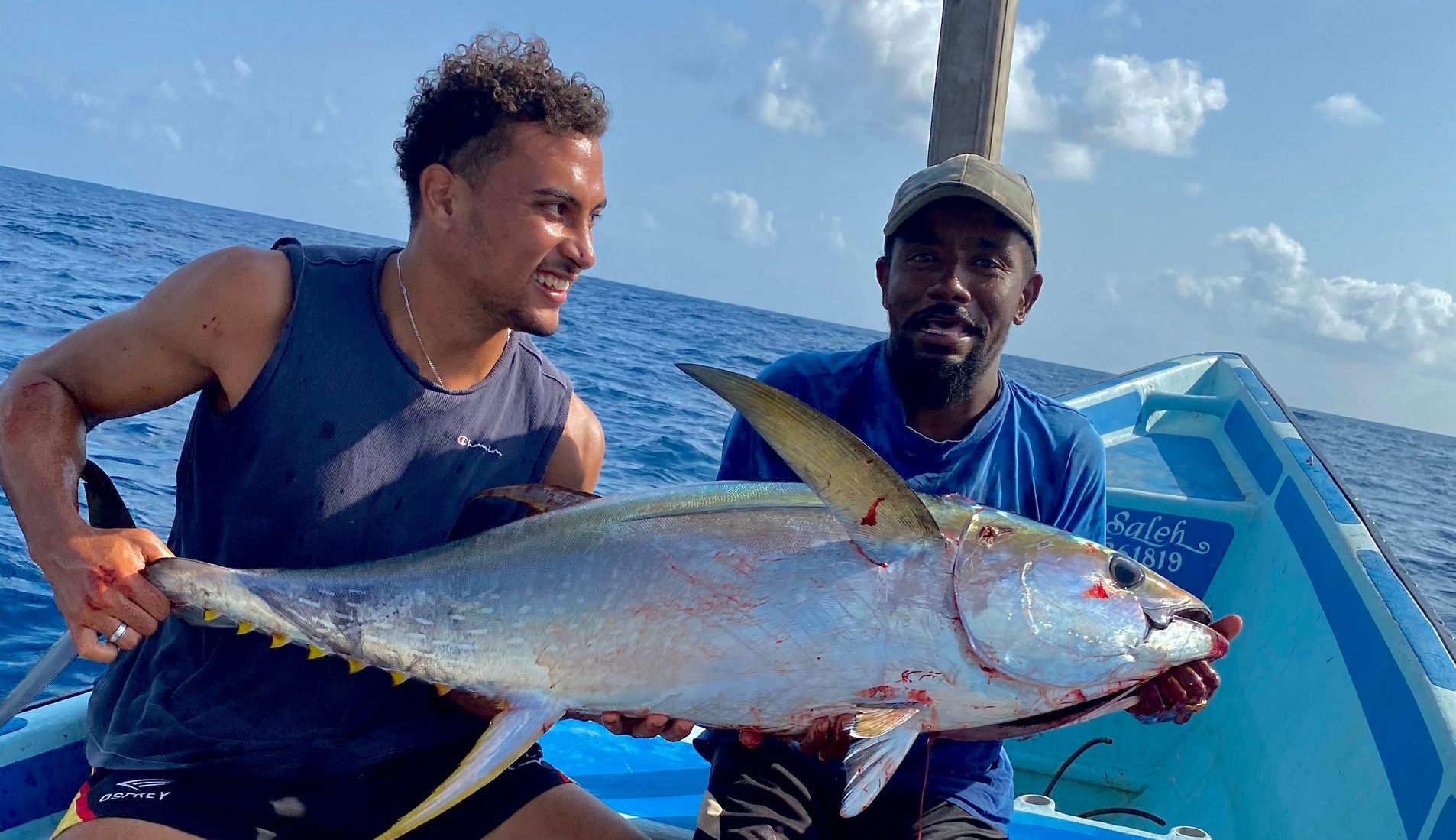 Local fishing experience in Lamu Island where guests catch a large fish during a guided ocean fishing activity offered by Banana House.