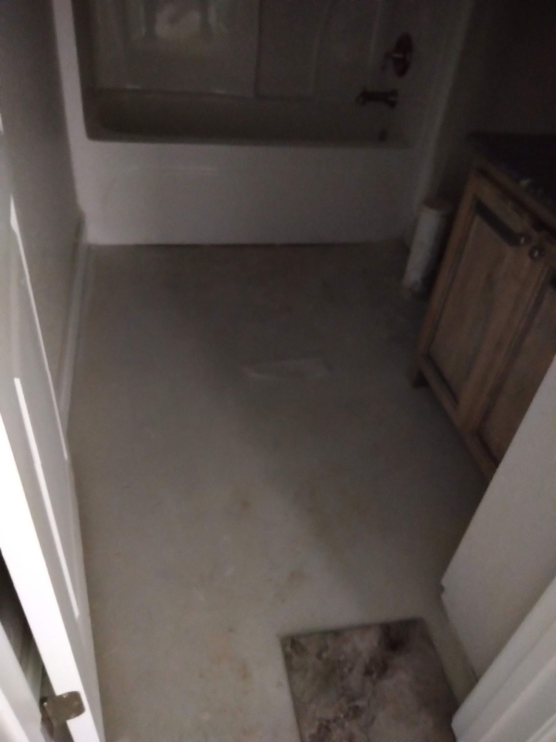Small bathroom with a sink, cabinet, and tiled floor, viewed from the doorway.