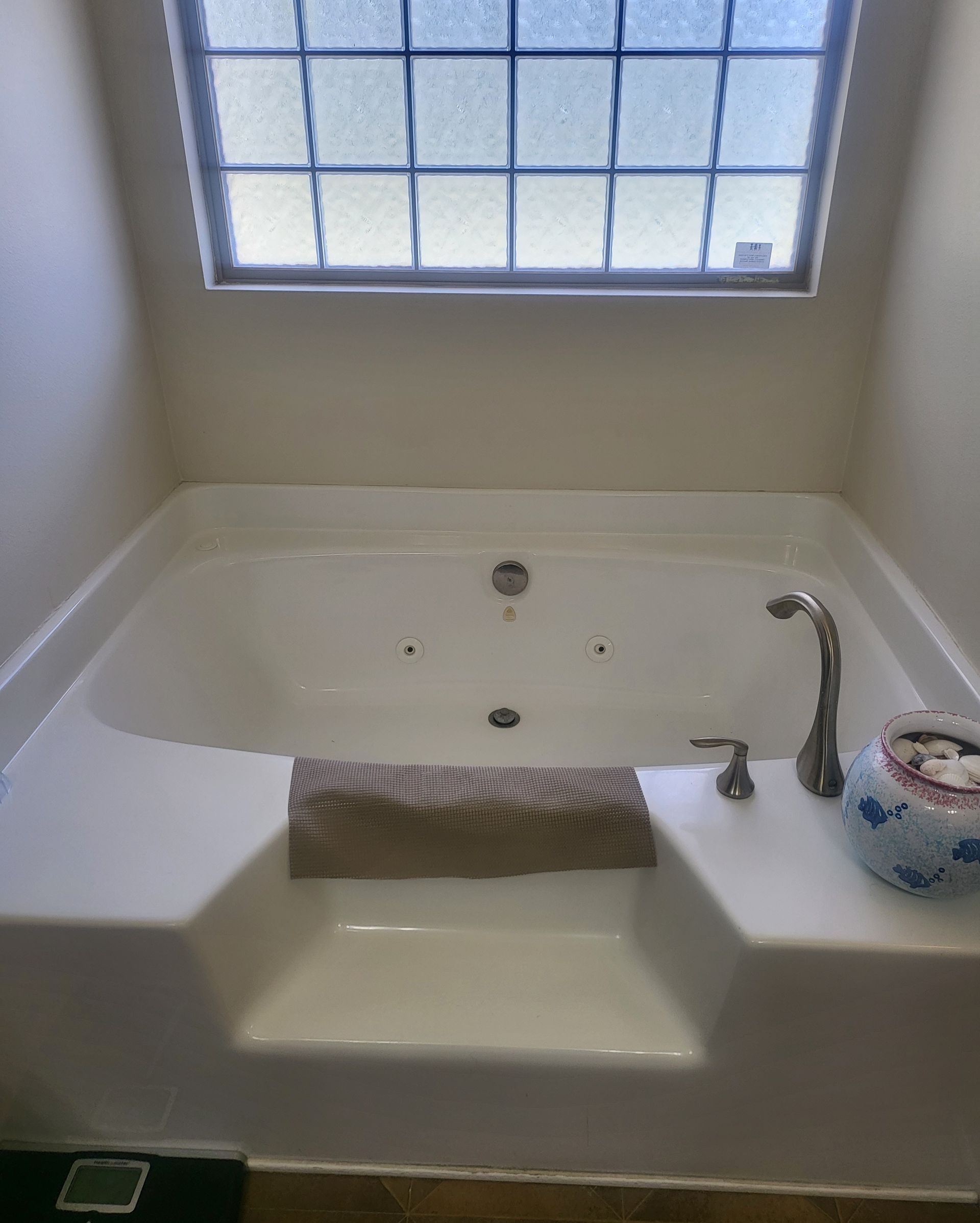 Modern bathroom with dark tile floor, freestanding tub, double vanity, and glass shower.