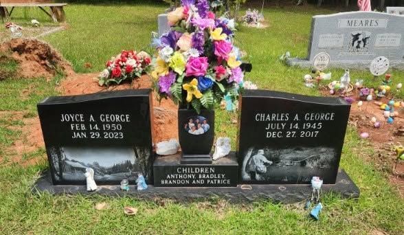 Two dark granite pedestals with hand and foot impressions, each with a circular opening at the top.