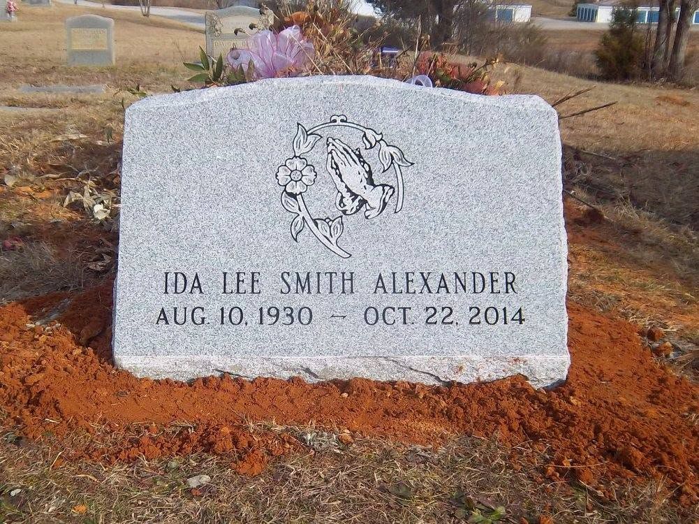 Black headstone with engraved text: 