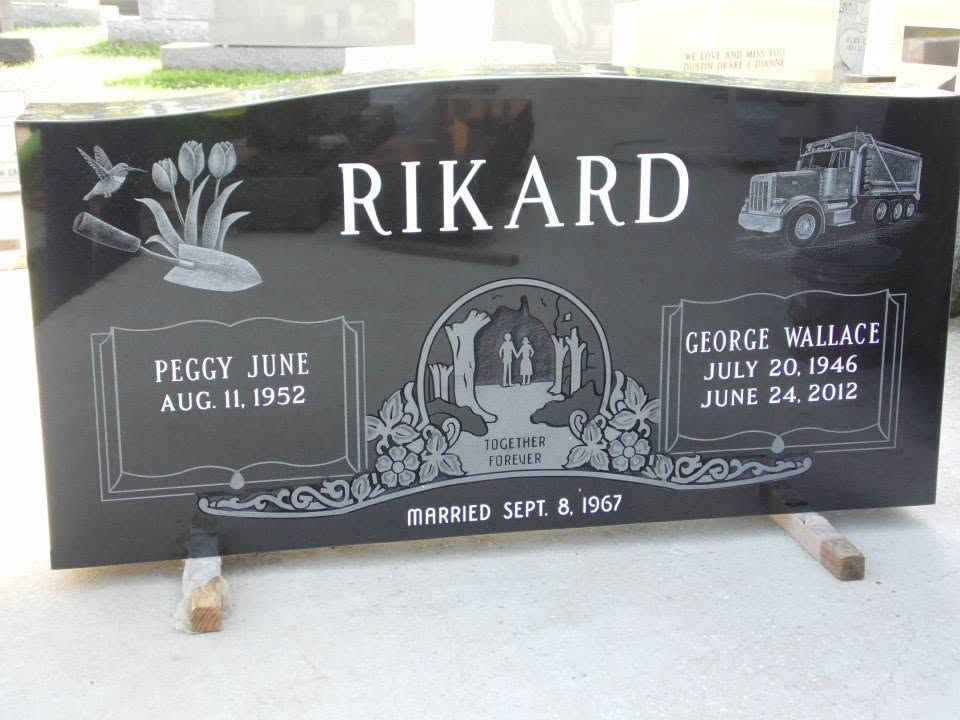 Two dark granite pedestals with hand and foot impressions, each with a circular opening at the top.