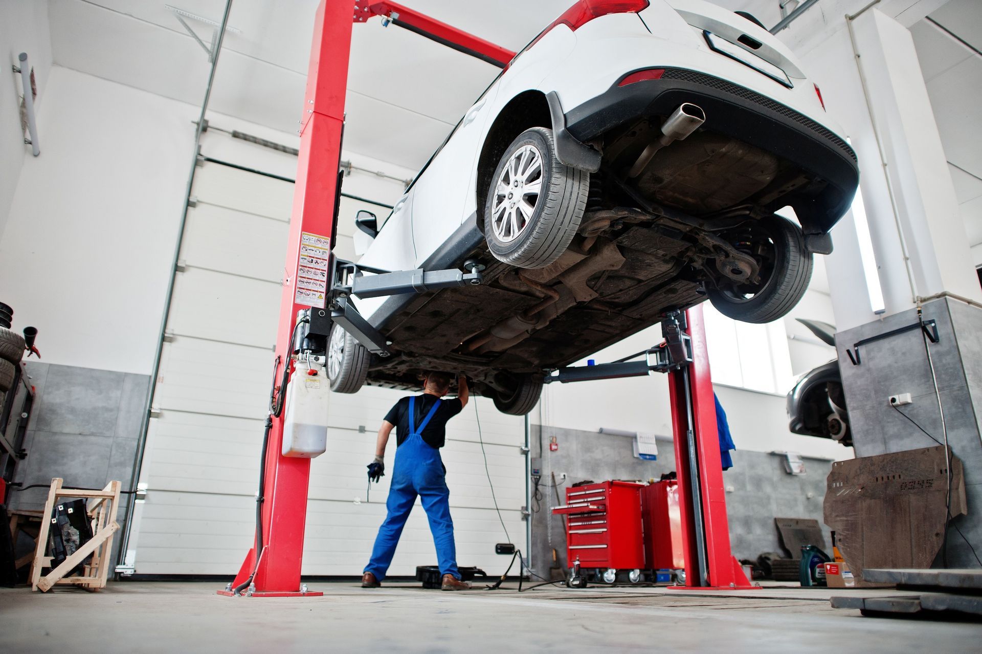 A mechanic in uniform working in auto service.