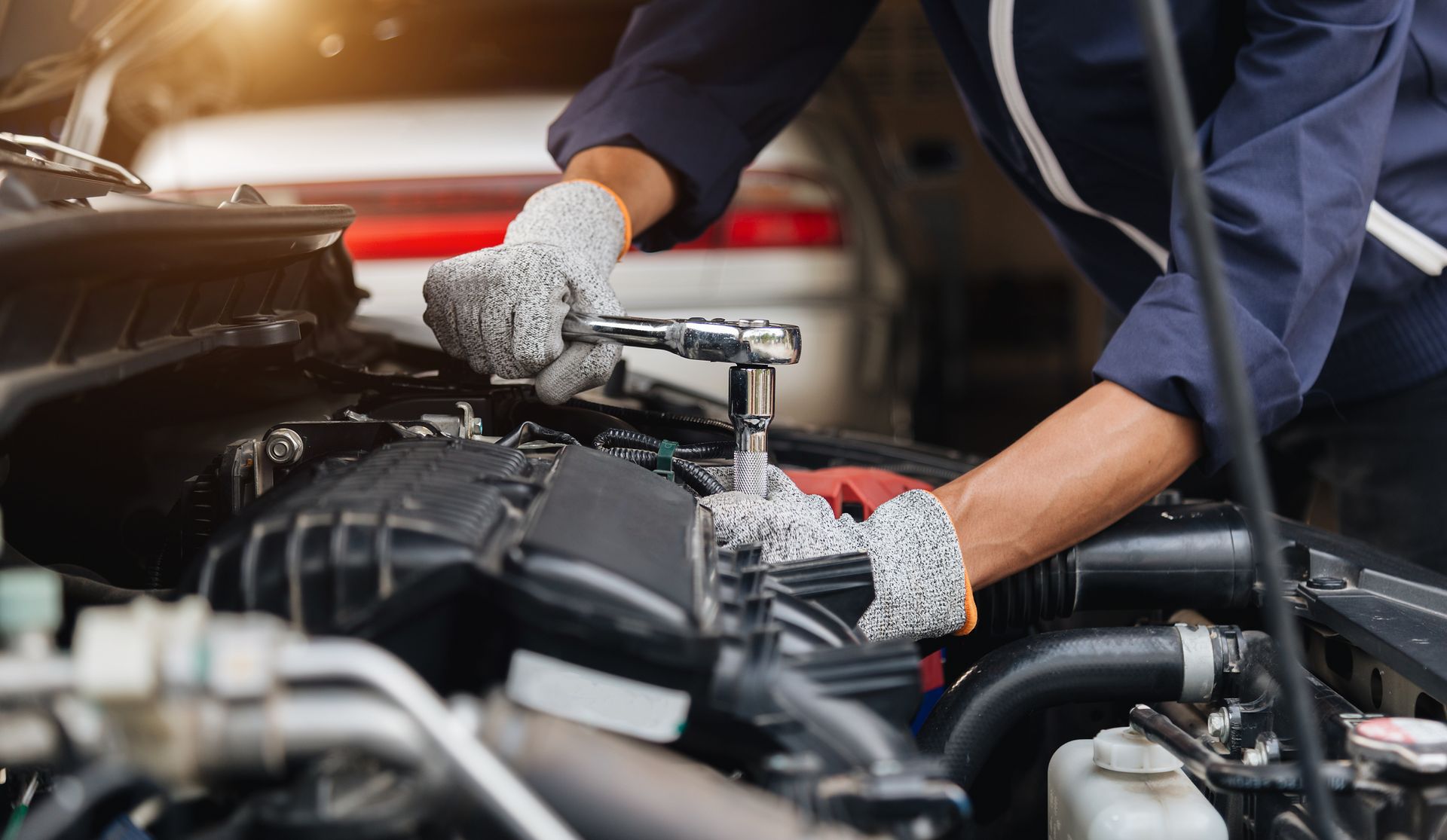 A mechanic is working on a car.