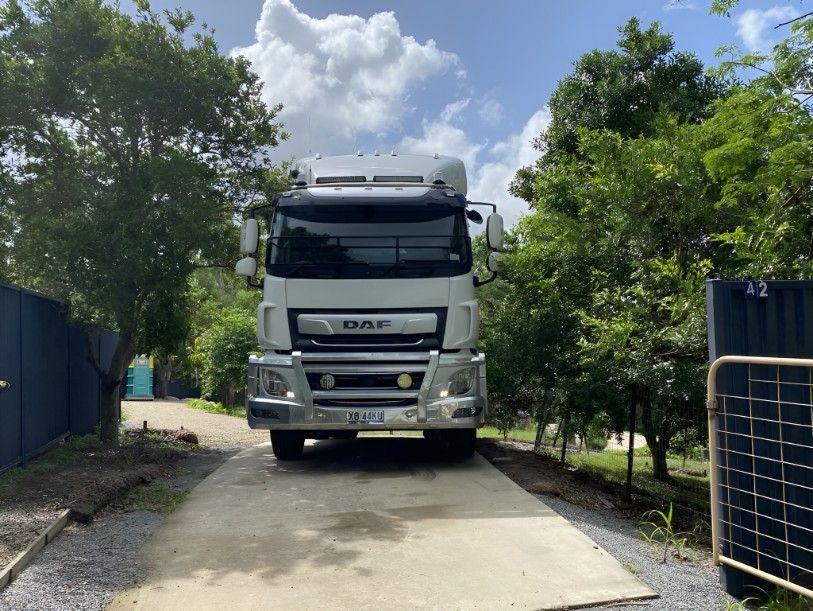 A White Truck is Parked on a Gravel Road Next to Trees — Water TopUps Gympie in Curra, QLD