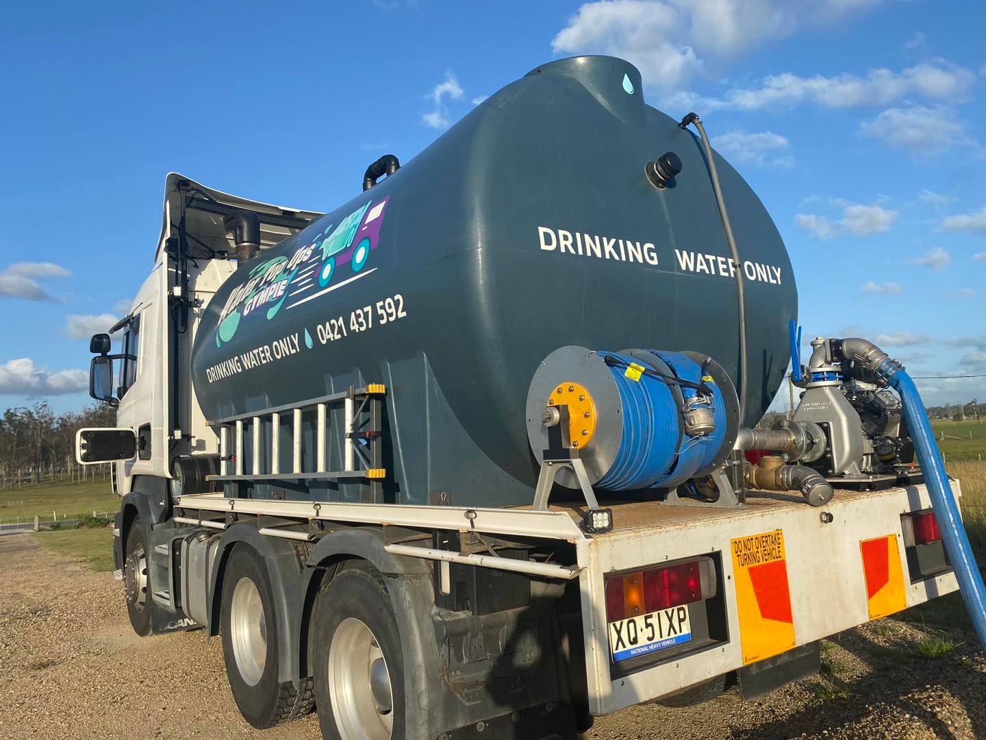 Water tanker truck with a blue tank labeled