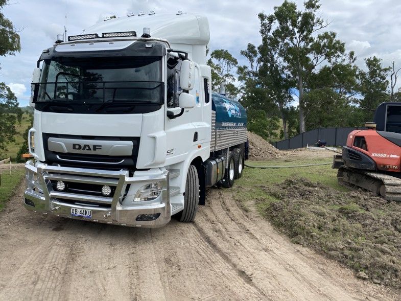 A White Truck is Parked on the Side of a Dirt Road — Water TopUps Gympie in Curra, QLD