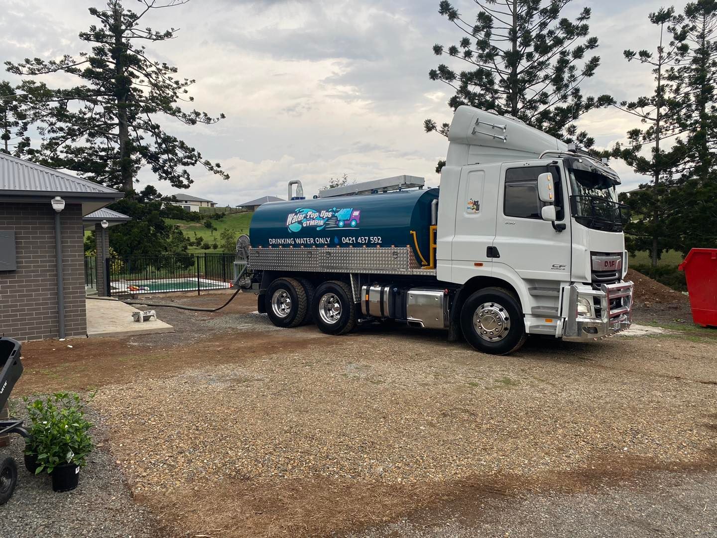 White Tanker Truck Parked on Gravel Near a House — Water Top Ups Gympie in Curra, QLD
