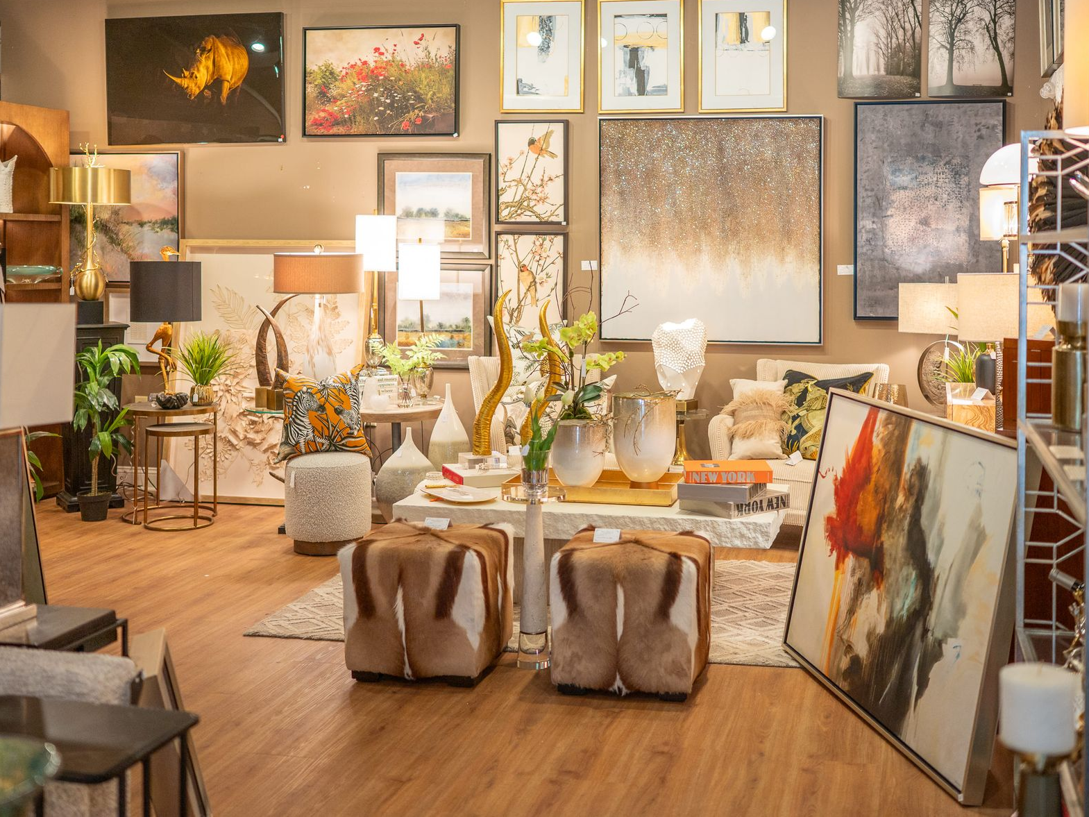 Interior decor store display with artwork, lamps, and furniture.
