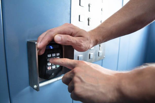 A Person Pressing A Button On A Wall With Their Finger — Thornton, CO — Thornton Westminster Locksmith