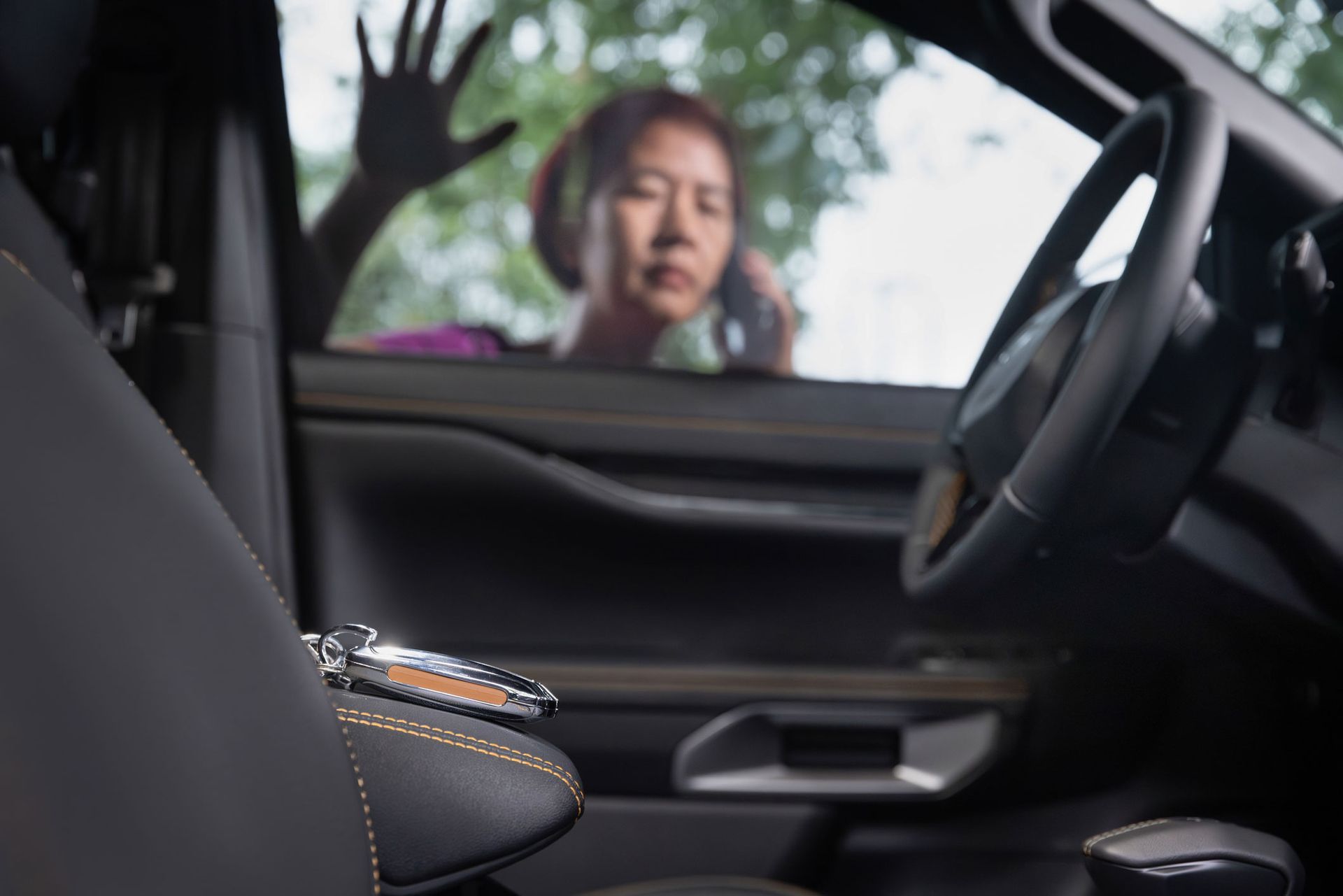 A Woman Sitting In A Car Talking On A Cell Phone — Thornton, CO — Thornton Westminster Locksmith