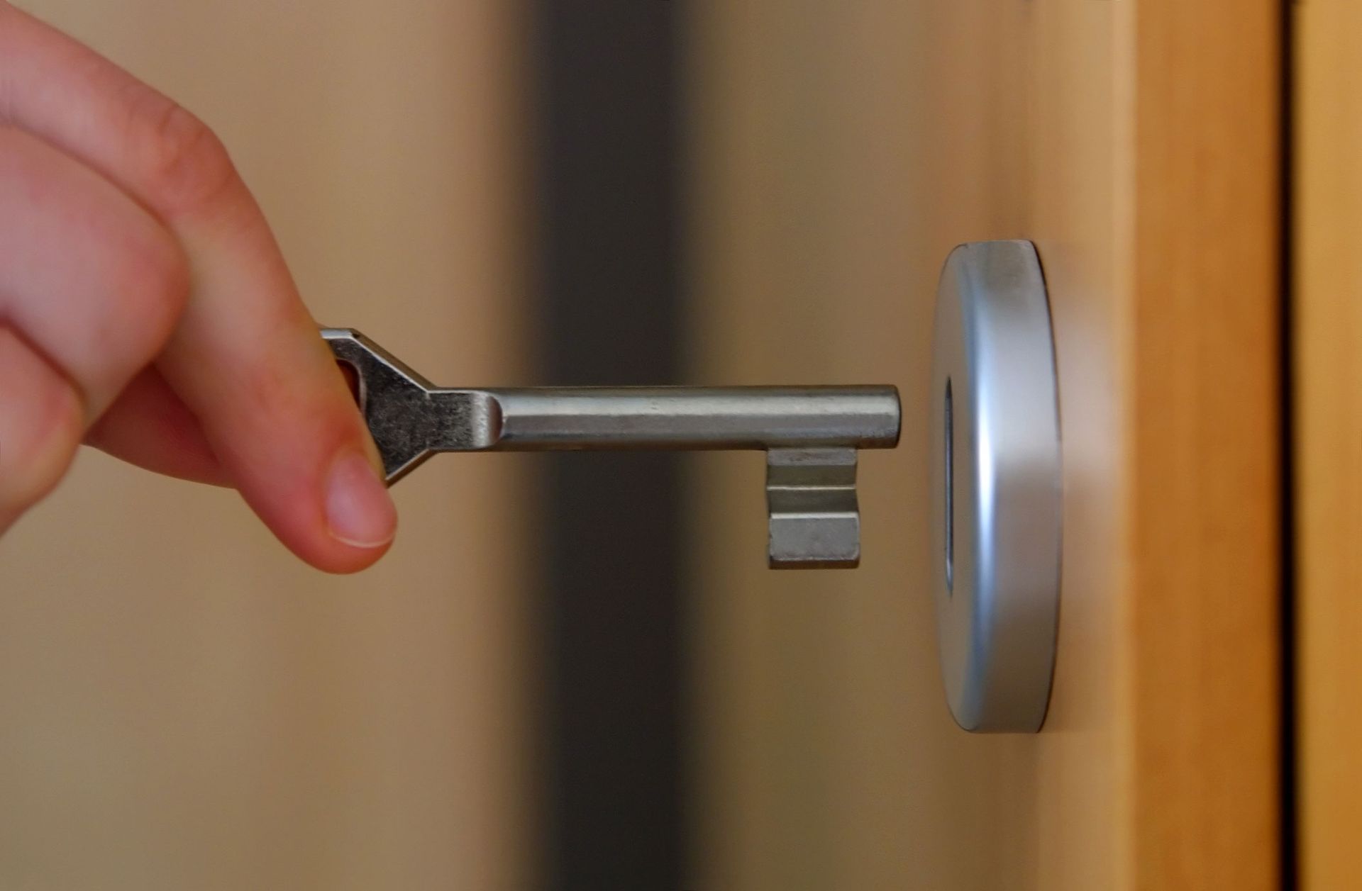 A Person Holding A Key In A Door Lock — Thornton, CO — Thornton Westminster Locksmith