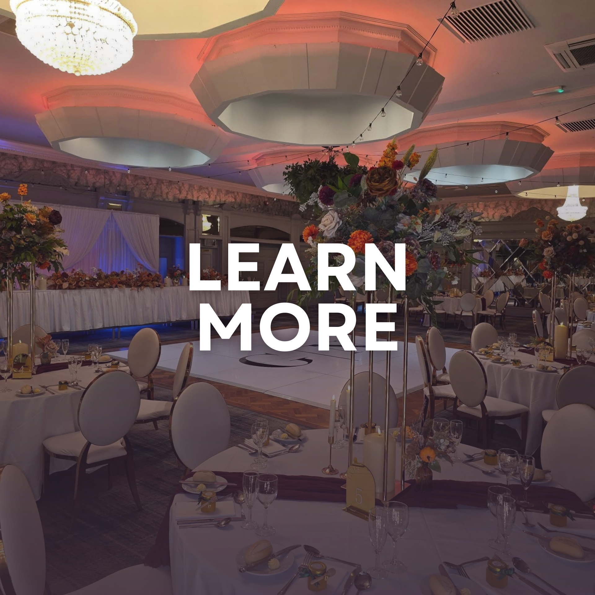 Elegant floral wedding aisle with pink lighting and “LEARN MORE” text overlay