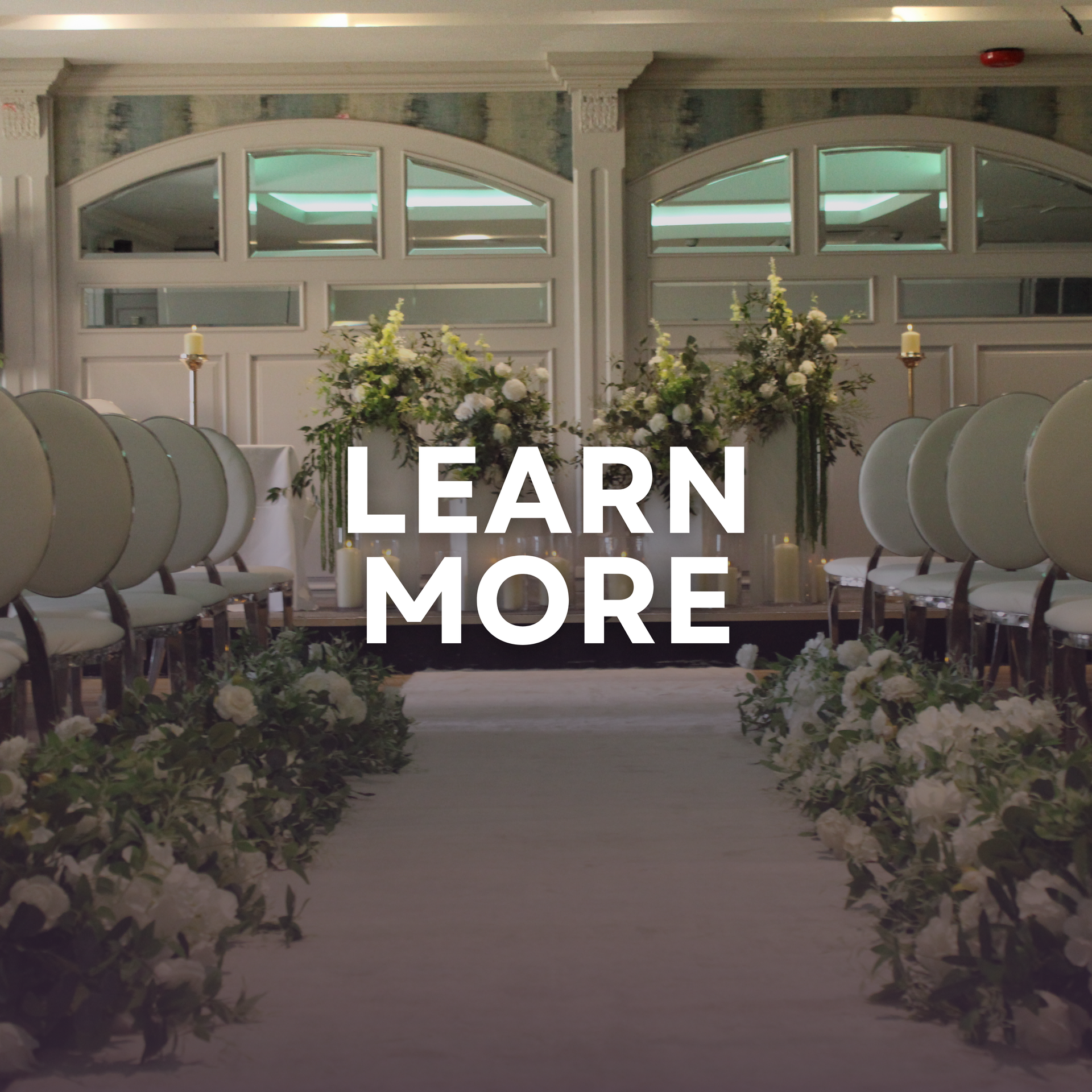 Floral event display with gold frame and neon sign, overlaid with “LEARN MORE” text