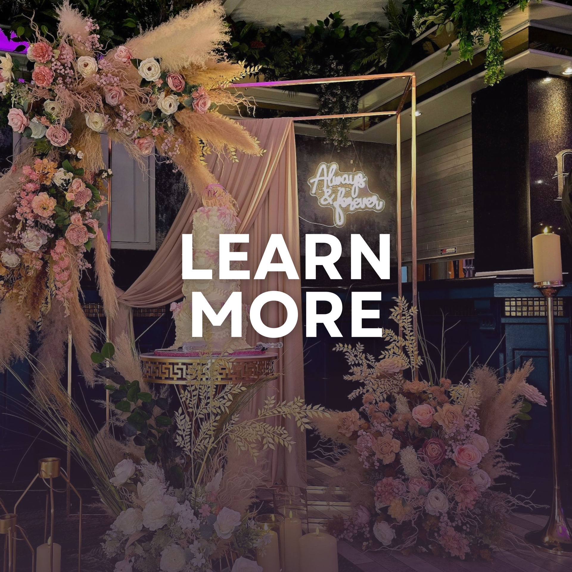 Floral event display with gold frame and neon sign, overlaid with “LEARN MORE” text