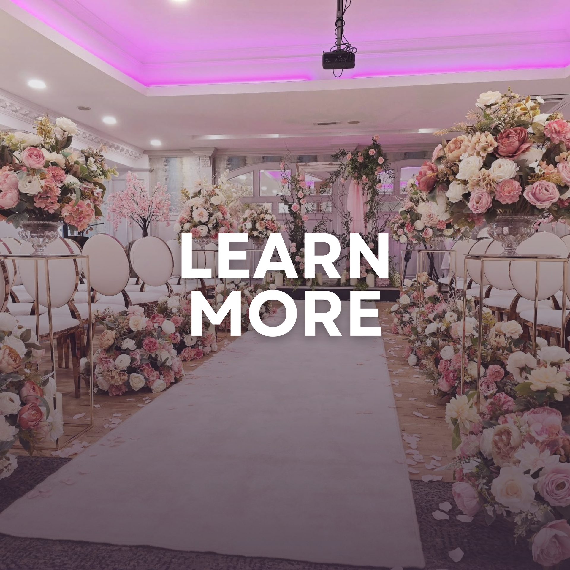 Elegant floral wedding aisle with pink lighting and “LEARN MORE” text overlay