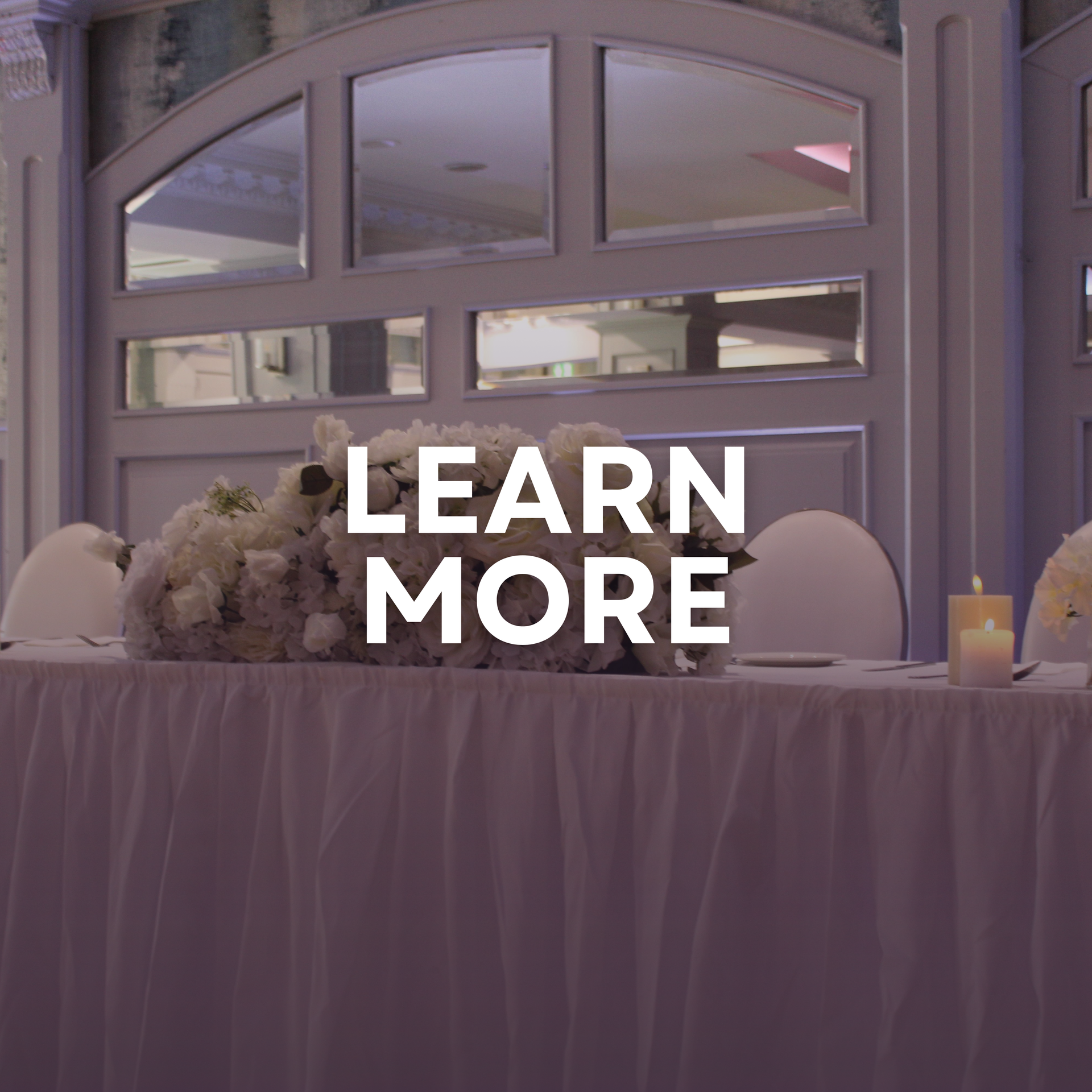 Elegant banquet hall with round white-clothed tables and blue lighting, overlaid with “LEARN MORE” text