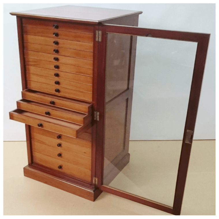 A wooden cabinet with drawers and a glass door