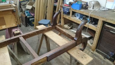 A wooden table is being built in a workshop.