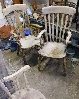 Two wooden rocking chairs are sitting next to each other in a room.