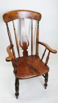 A wooden chair is sitting on a white surface