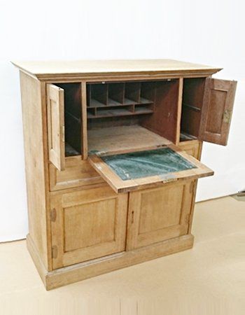 A wooden cabinet with the doors open and a glass top.