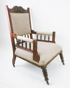 A wooden chair with a white cushion on a white background