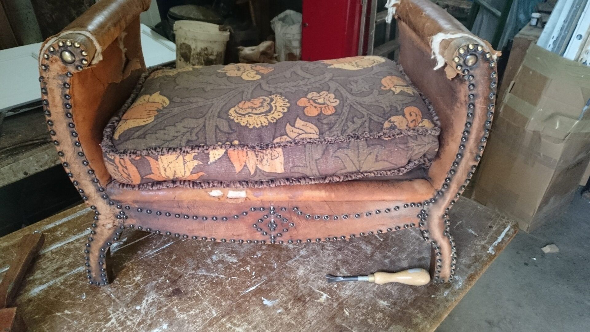 A chair is sitting on a wooden table with a screwdriver next to it