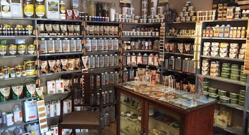 A store filled with lots of shelves and bottles of food.