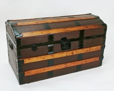 A brown and wooden trunk with a lock on it