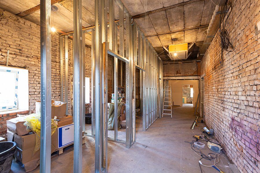 A room under construction with brick walls and metal frames.