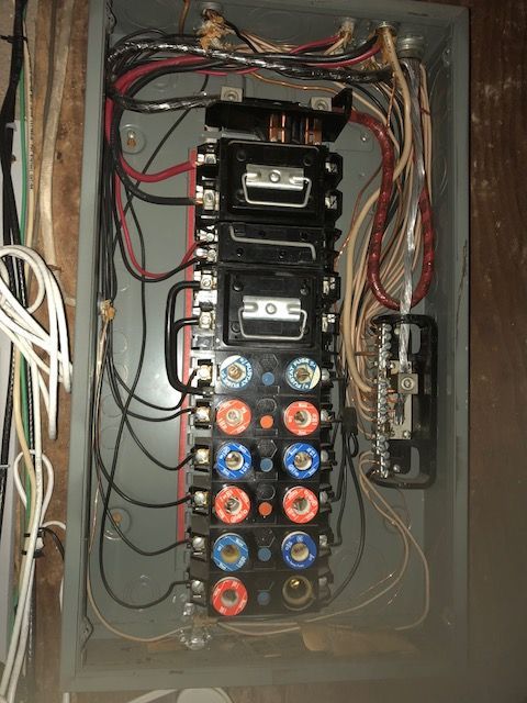 A very messy electrical box with a lot of wires