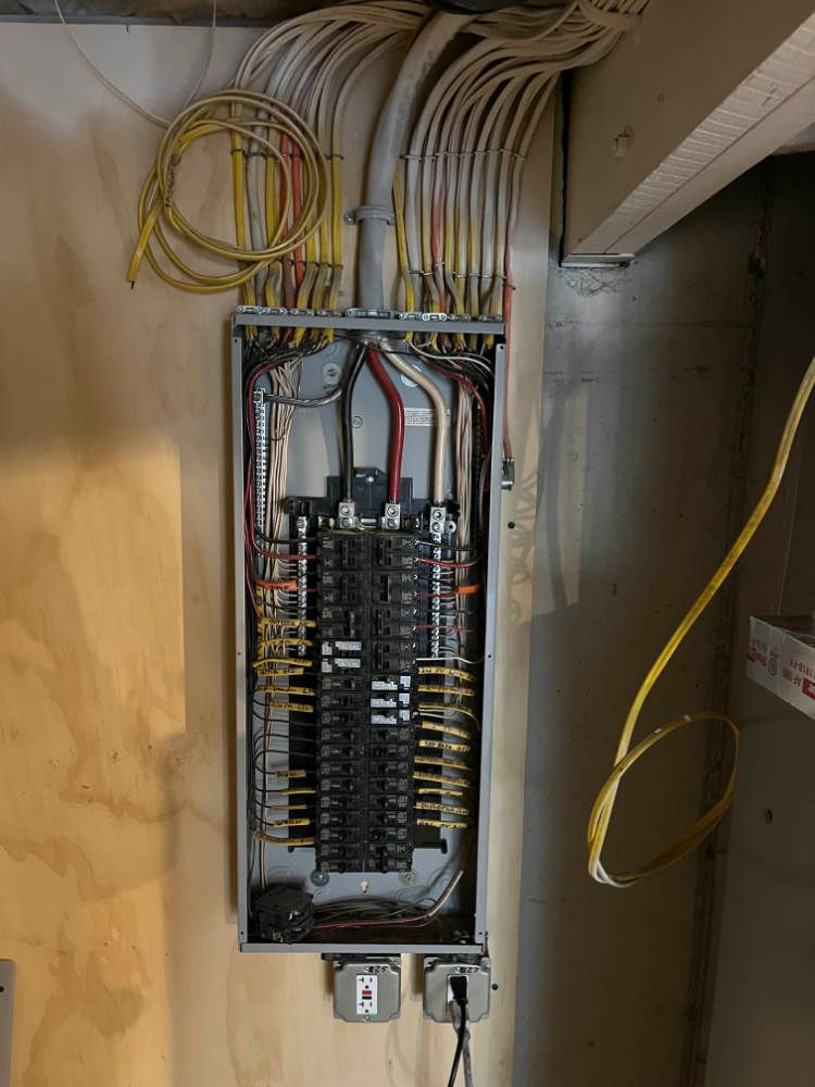 A electrical box with a lot of wires coming out of it.