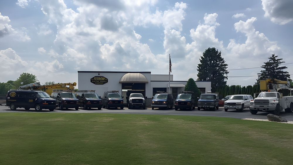 A row of trucks are parked in front of a building