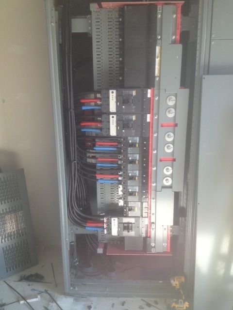 A close up of a electrical box with a lot of wires coming out of it.