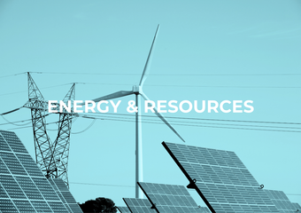 Solar panels, wind turbine, and power lines against a teal sky; text reads 