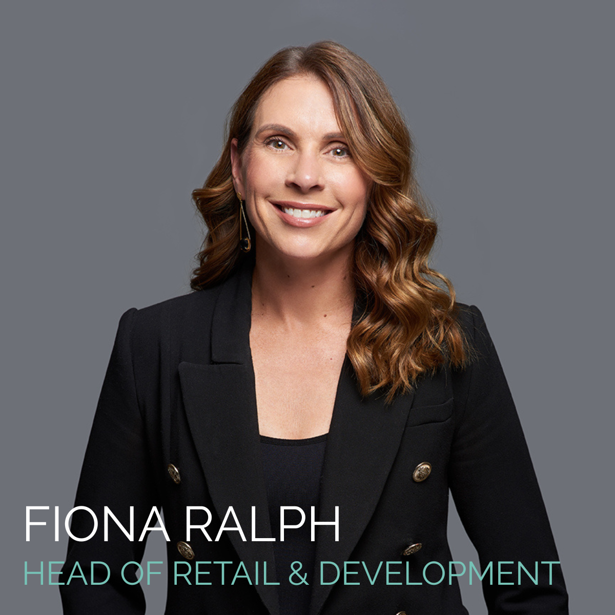 Fiona Ralph, Head of Retail & Development, smiles in a black blazer against a gray backdrop.