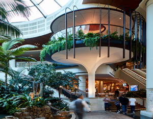 A large building with a circular staircase surrounded by plants
