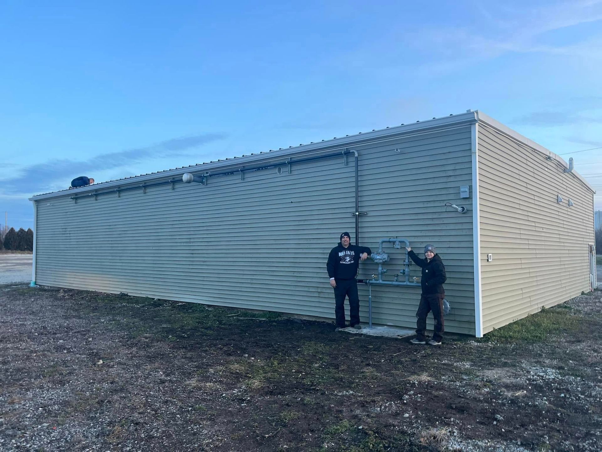 Two men are standing in front of a large building.