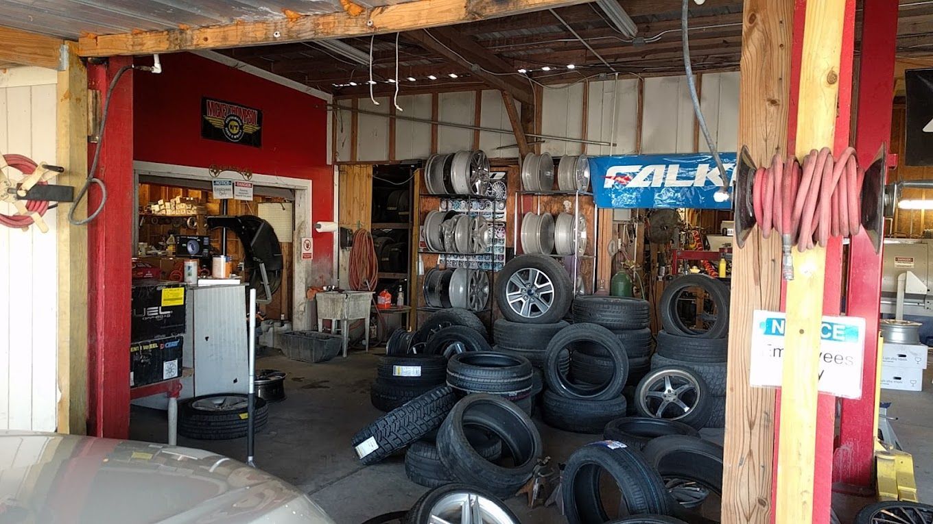 A garage filled with lots of tires and wheels.