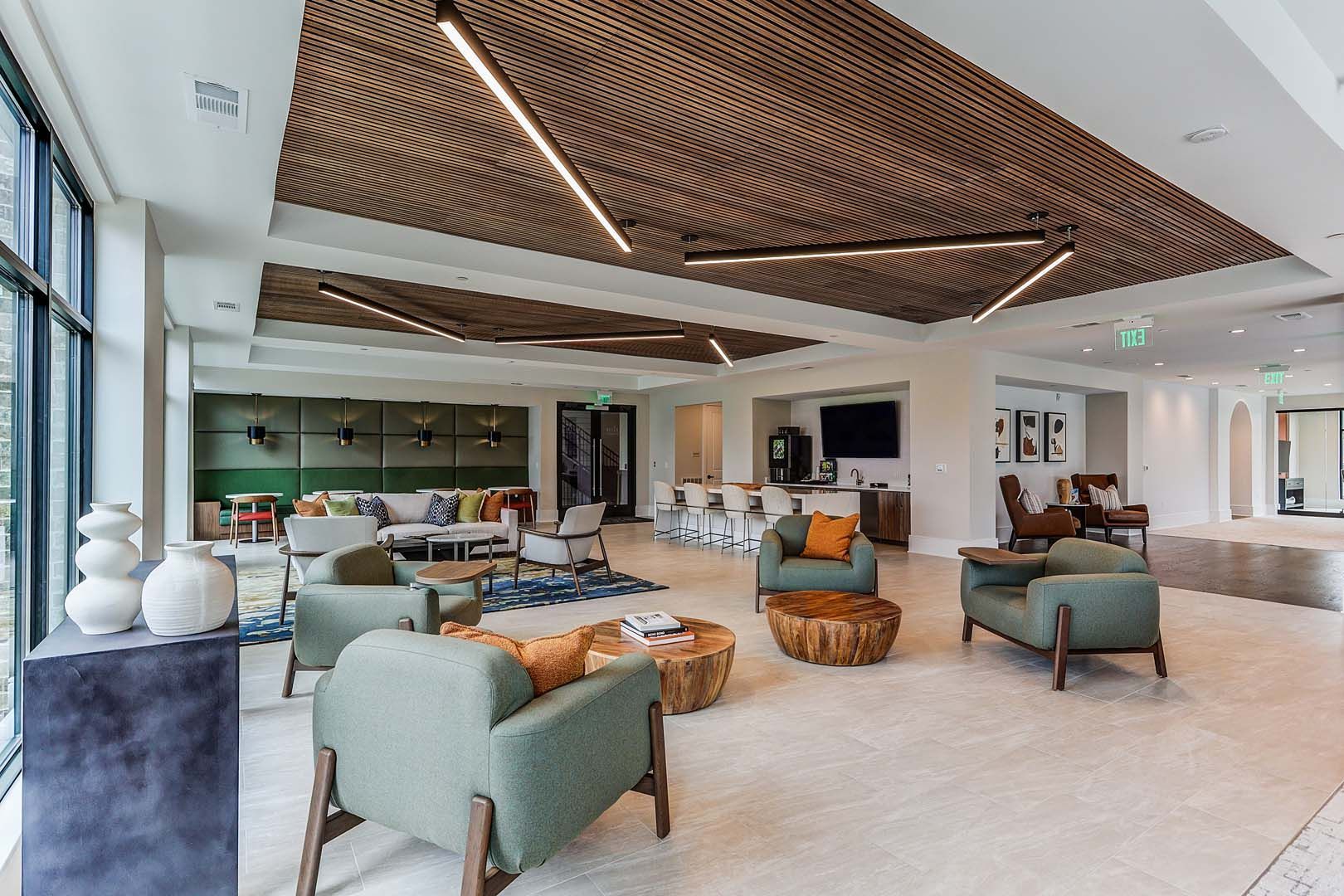 A large living room filled with furniture and a wooden ceiling.