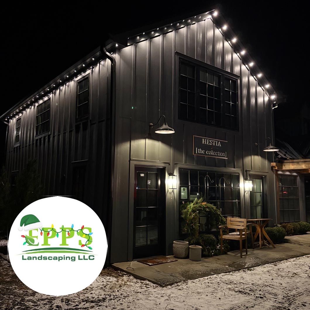 Dark barn-style landscaping office at night with string lights and a PFS Landscaping LLC logo watermark.