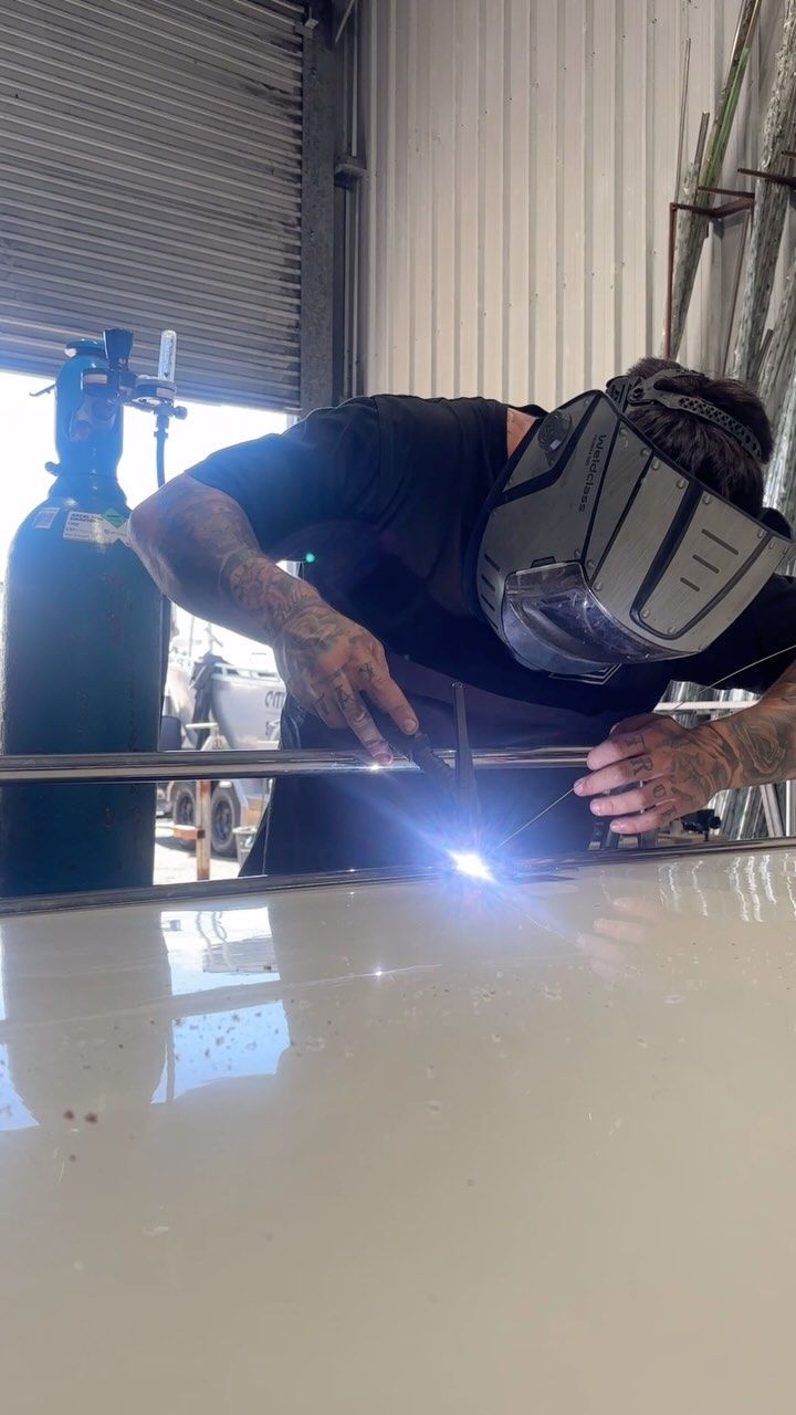 Person Welding Metal With a Mask on in a Workshop — Master Metals Fabrication in Labrador, QLD